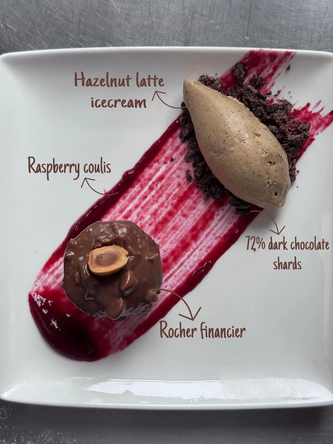 Rocher Financier plated — hazelnut-latte ice cream with raspberry coulis and dark chocolate shards